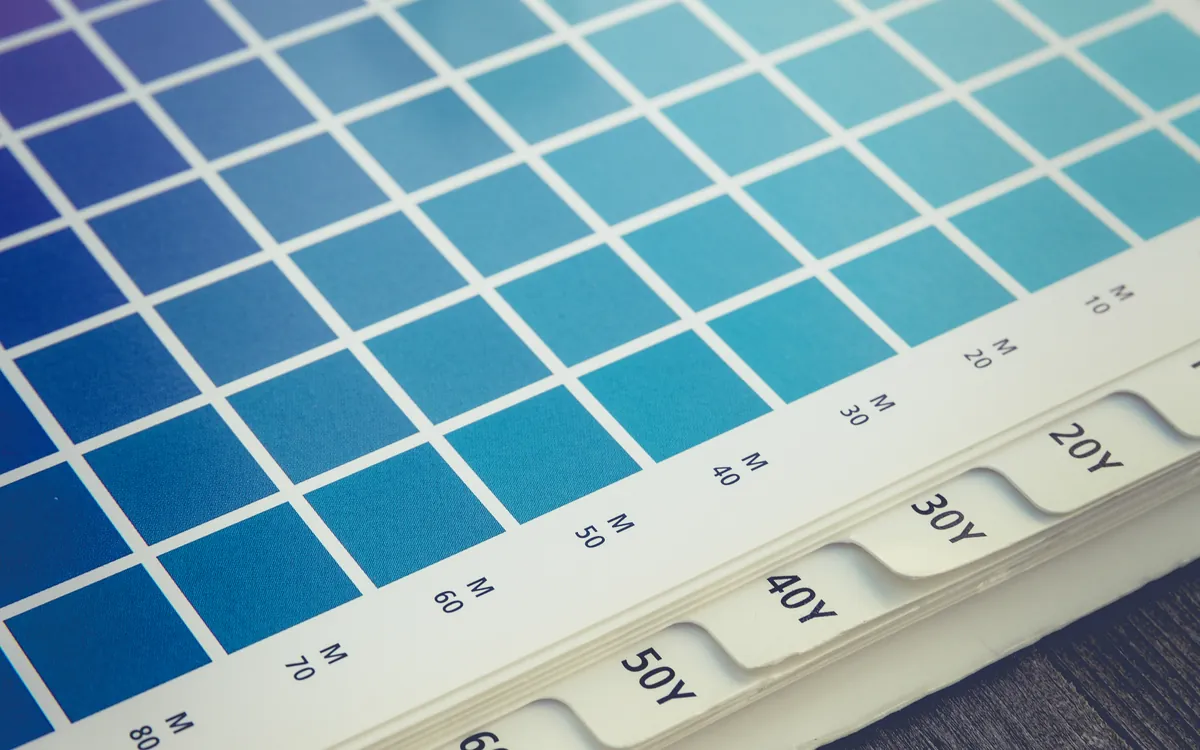 Color swatch chart with a magnifier on a desk